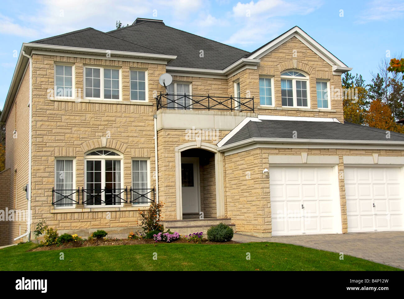 New detached single family luxury home with stone facade and double garage Stock Photo