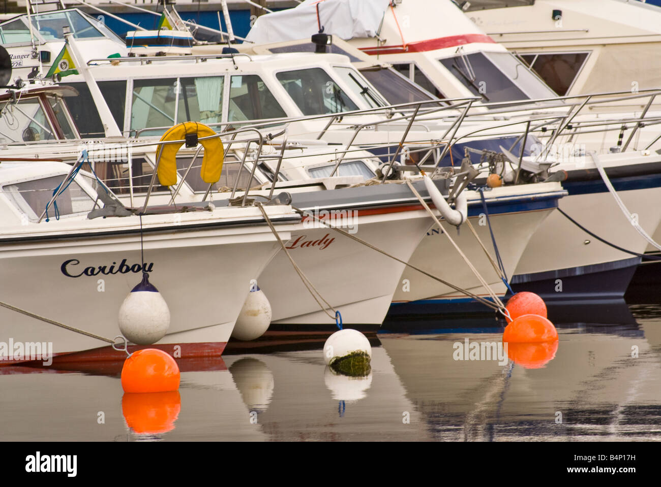 'motor boats' moored together on bouys Stock Photo