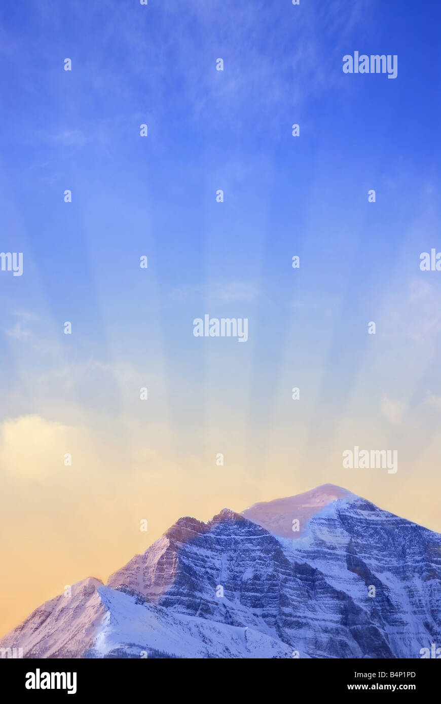 Sun rising behind a big snowy mountain background with sun rays Stock ...