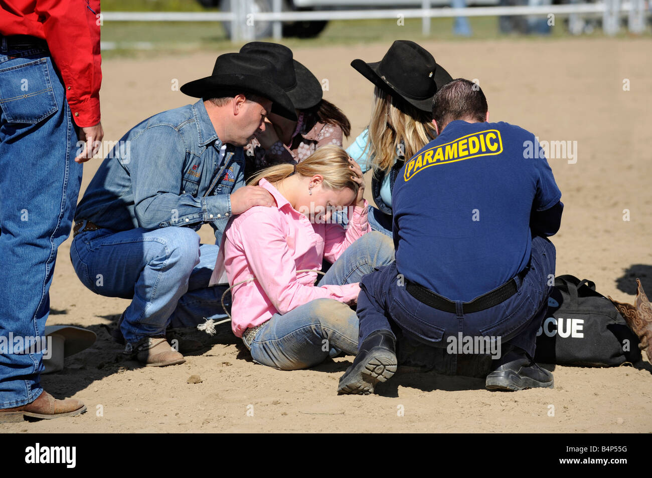 Rodeo female receives medical attention after falling of horse Stock Photo