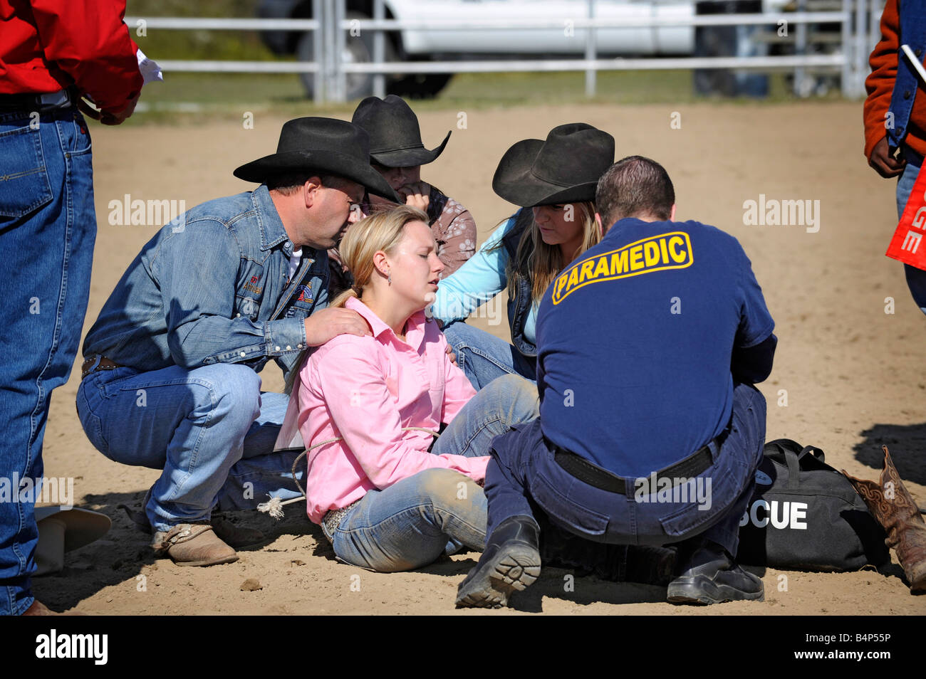 Rodeo female receives medical attention after falling of horse Stock Photo