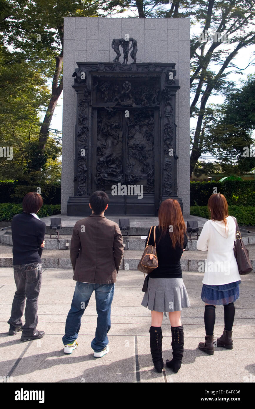Four young people in front of Auguste Rodin's - The Gates of Hell at the Museum of Western Art Ueno Park Tokyo Japan Stock Photo