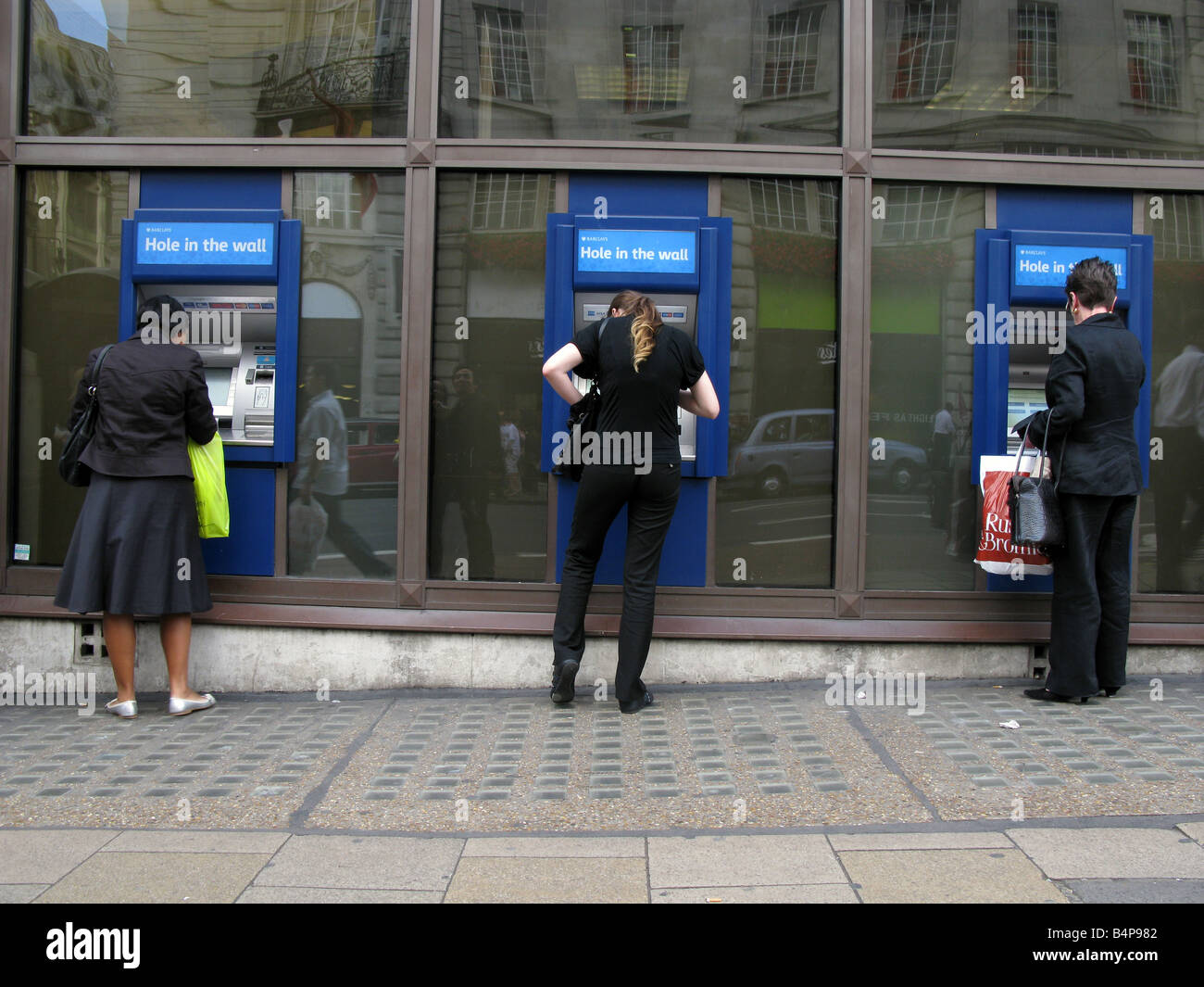 People withdrawing money from ATM, London, UK Stock Photo