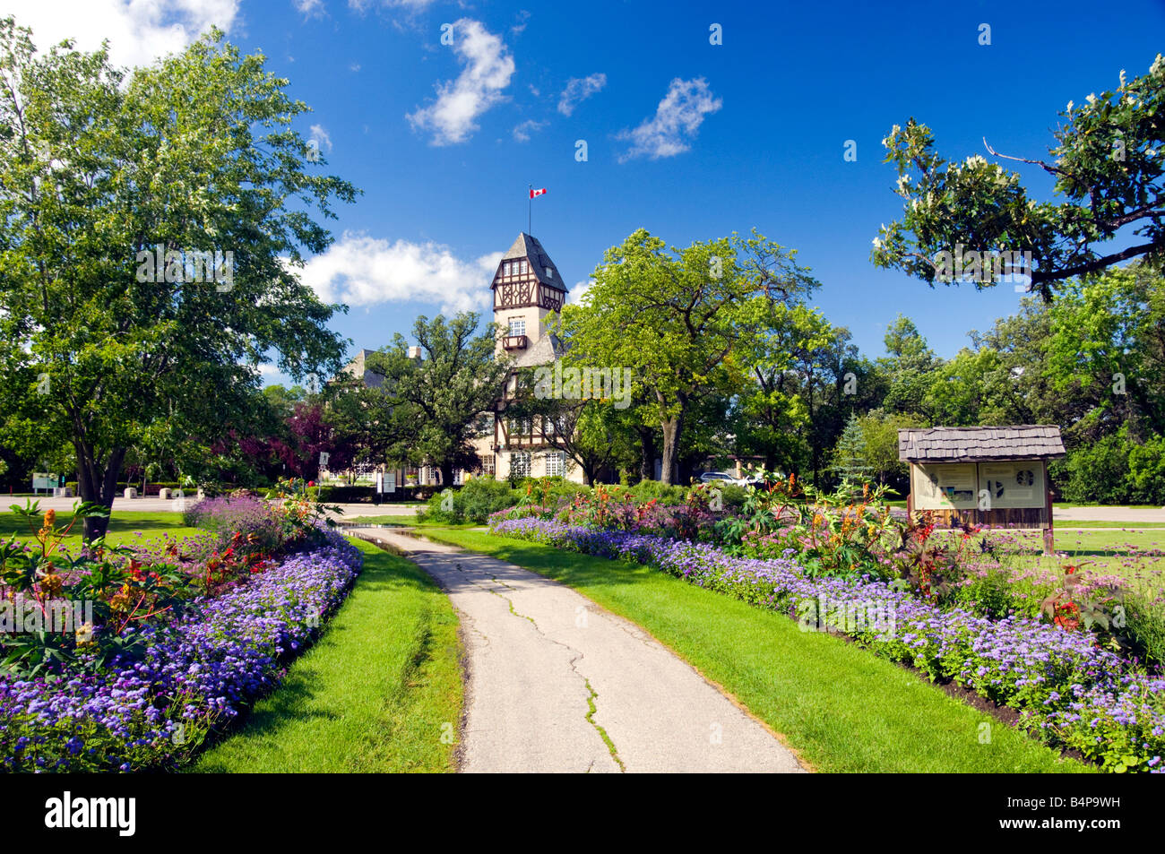 The pavilion at the Assiniboine Park with a pathway lined with decorative flowers in Winnipeg