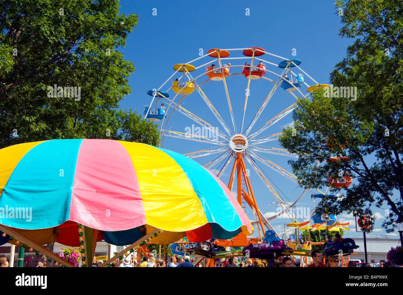A colorful midway with ferris wheel at the Corn and Apple Festival in Morden Manitoba Canada Stock Photo