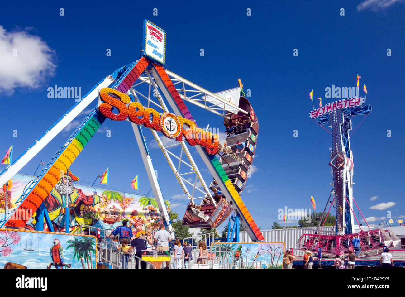 A colorful midway with ferris wheel at the Corn and Apple Festival in