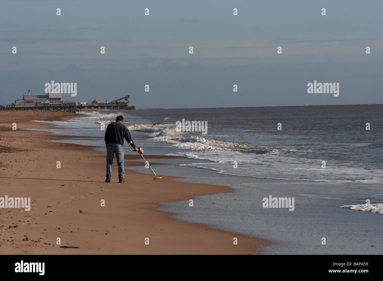 man with metal detector on beach Stock Photo