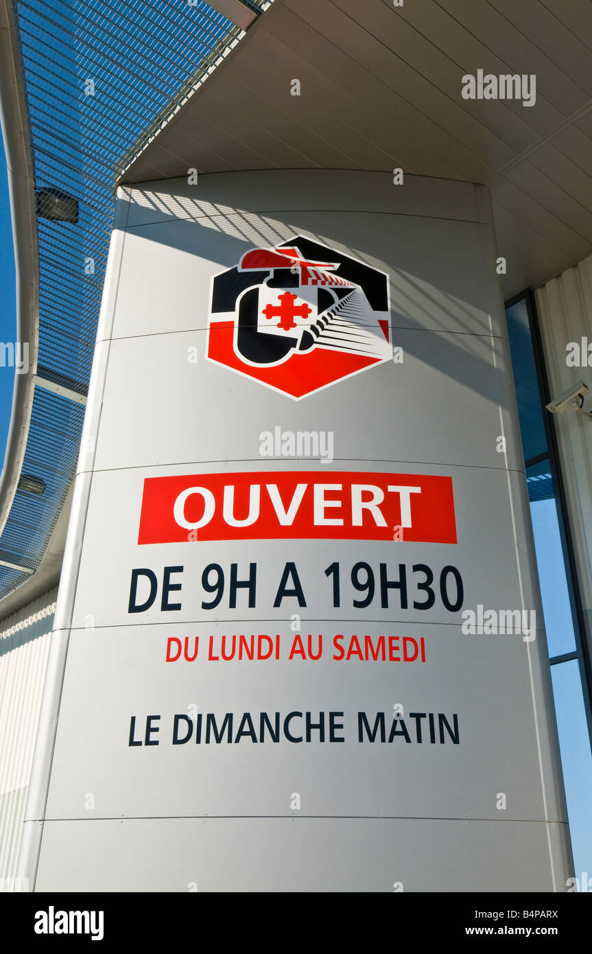 Opening times sign for new 'Intermarche' superstore, France. Stock Photo