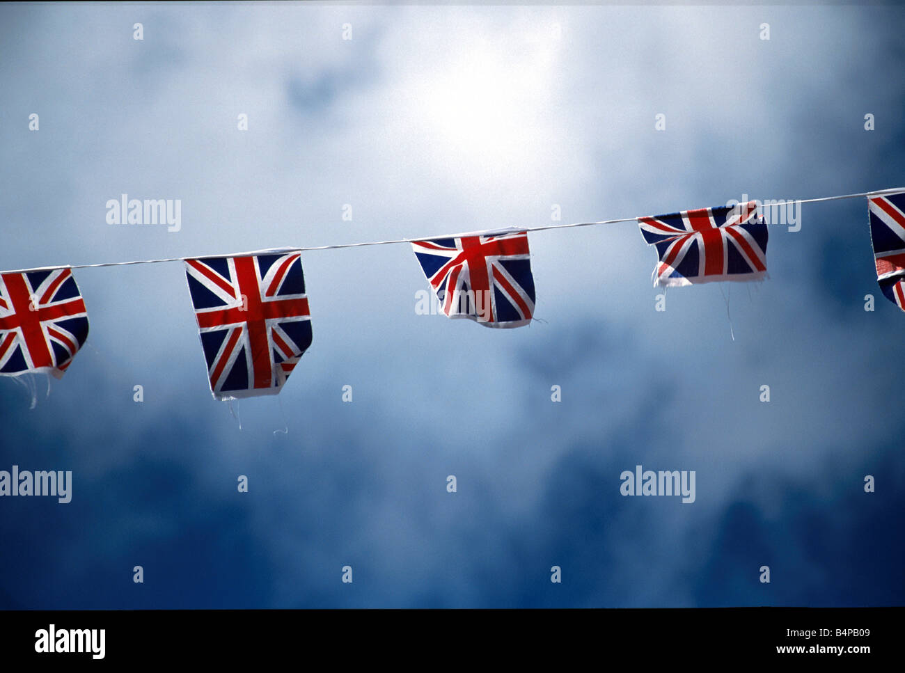 bunting of union jacks hung across a british street during a