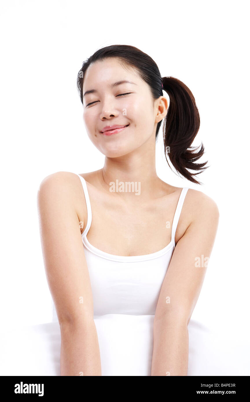 Young woman smiling, eyes closed Stock Photo