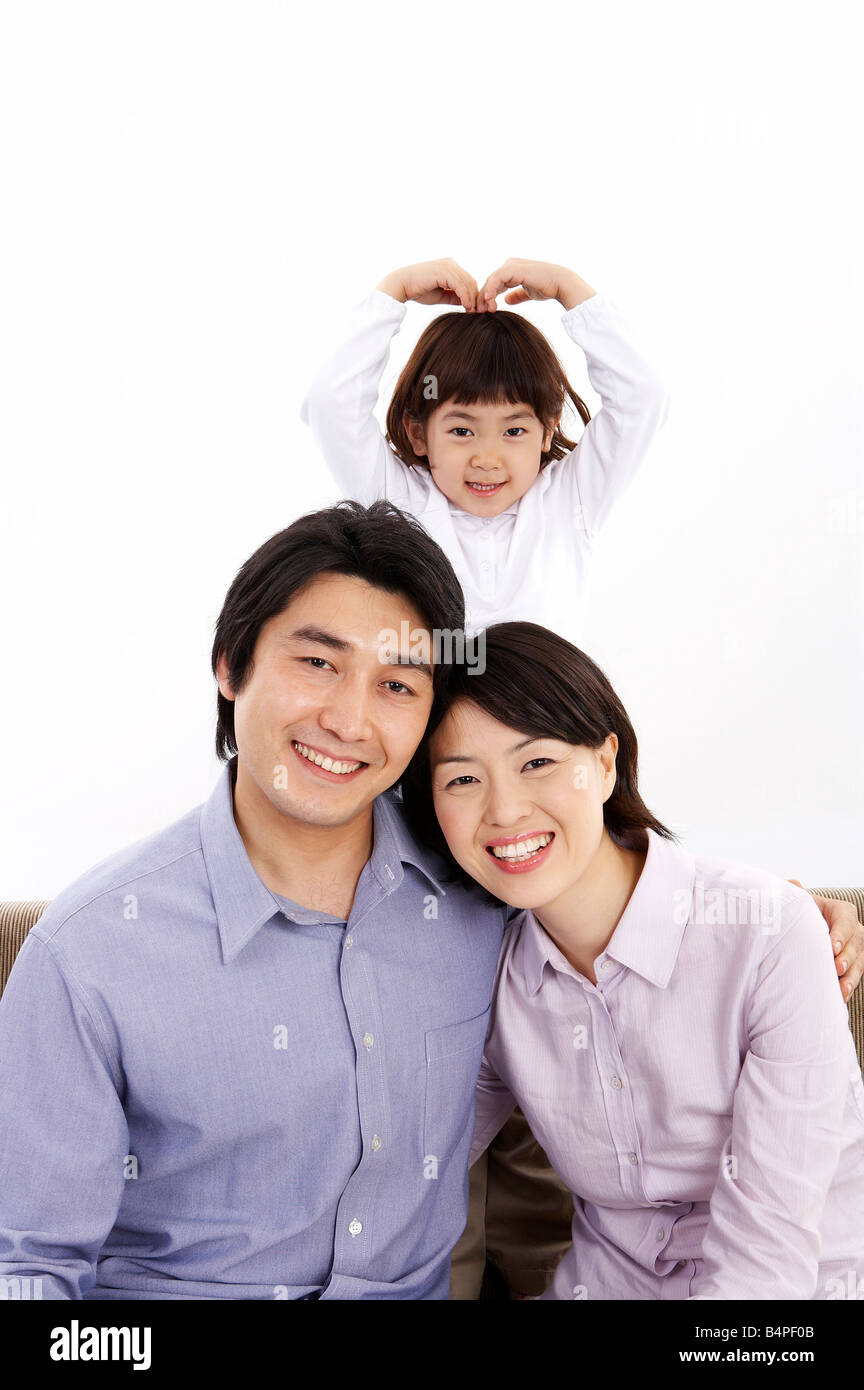 Father and mother smiling while daughter in background Stock Photo - Alamy