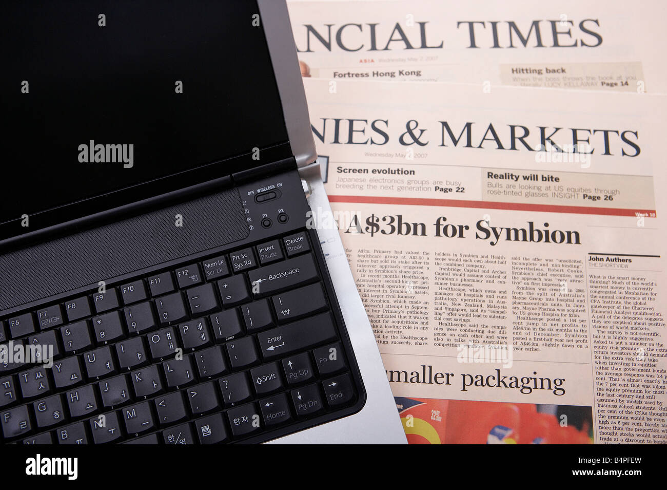 Laptop and newspaper, closeup Stock Photo Alamy