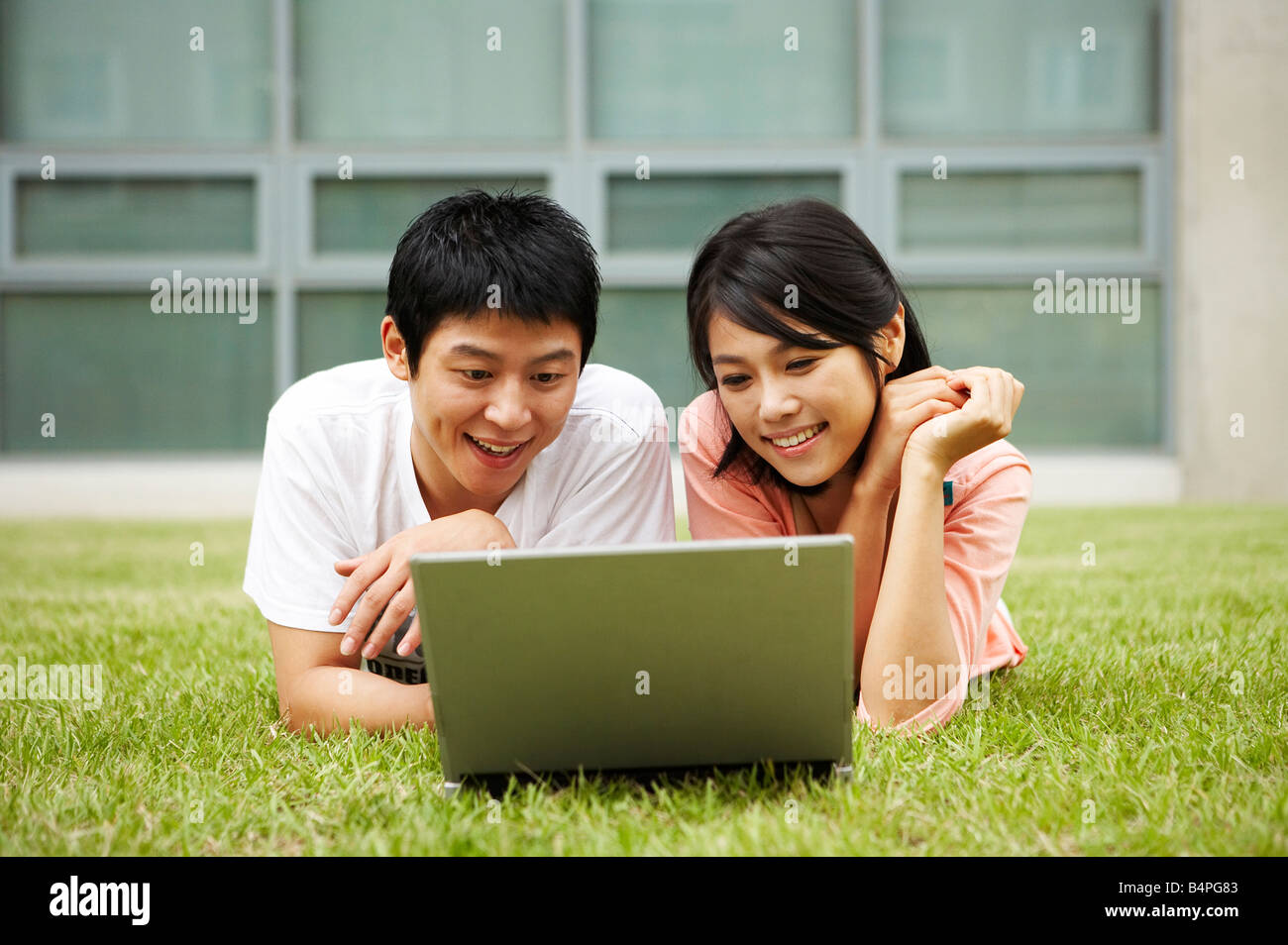 Man Woman Laptop Smiling Lying Happiness Grass Two People High Resolution Stock Photography And Images Alamy