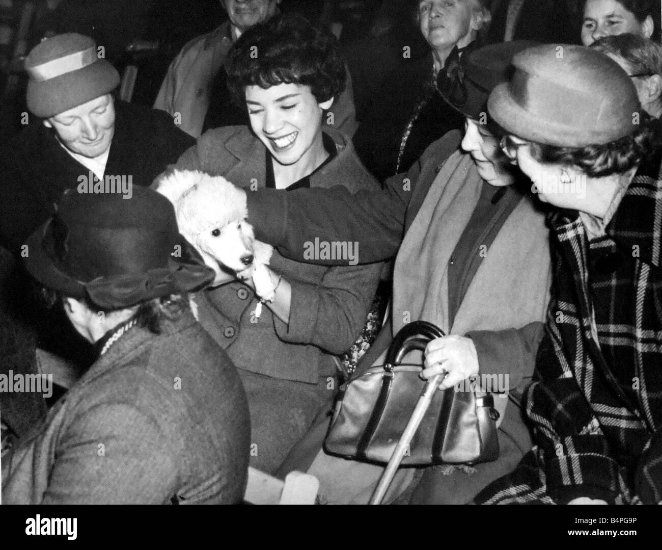 Shirley Bassey the Cardiff born singer pictured with her poodle during a concert held at Trelai Welfare Hall Ely Cardiff Shirley chats with some admiring old age pensioners left to right Mrs B Hering Miss Bassey Mrs S Phillips and Mrs E Perry 26th Nov 1958 Stock Photo
