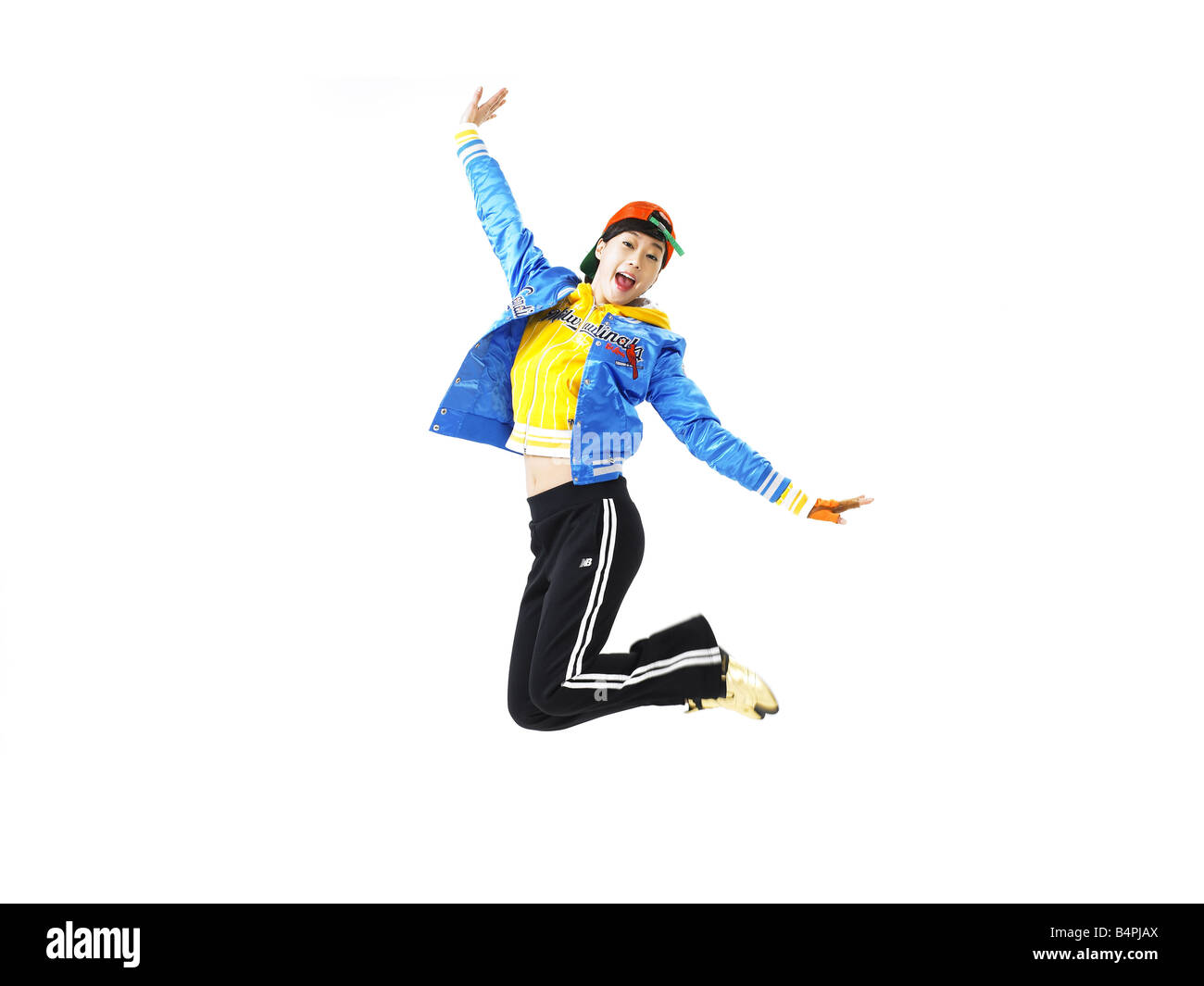 Young woman jumping against white background Stock Photo - Alamy