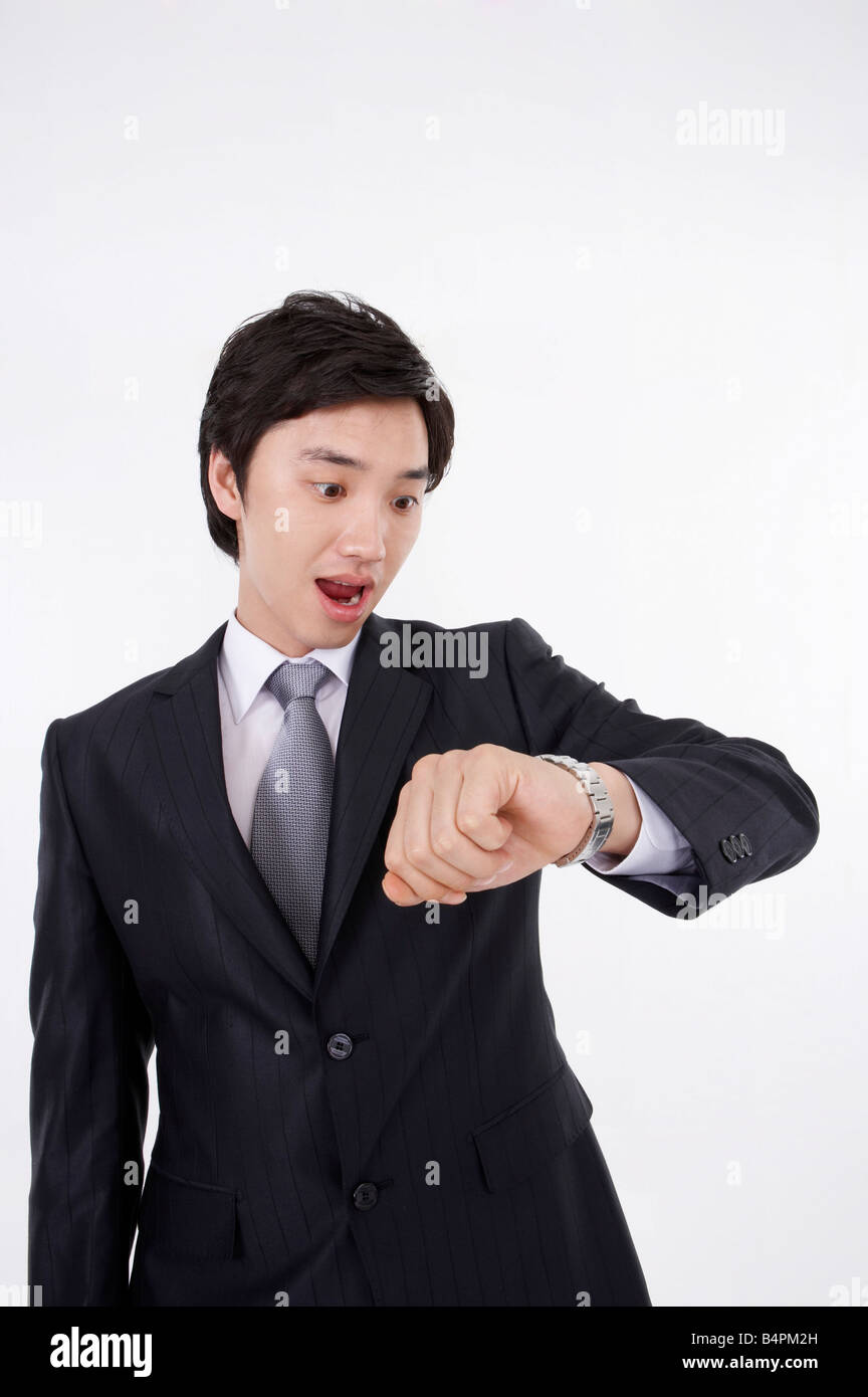 Young businessman checking time Stock Photo - Alamy