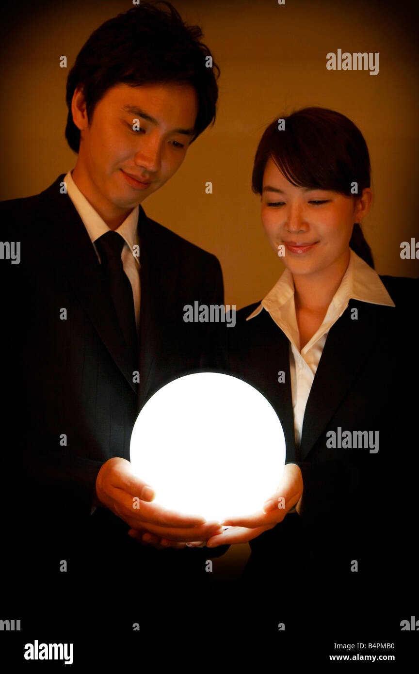Businessman looking into crystal ball hi-res stock photography and ...