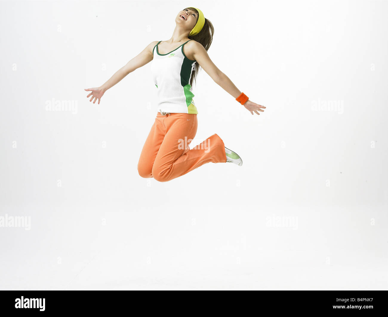 Young woman kneeling with arms outstretched Stock Photo Alamy