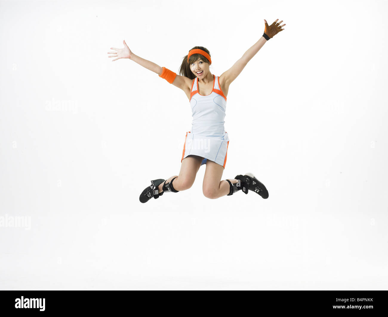 Young woman with arms raised, smiling, portrait Stock Photo - Alamy