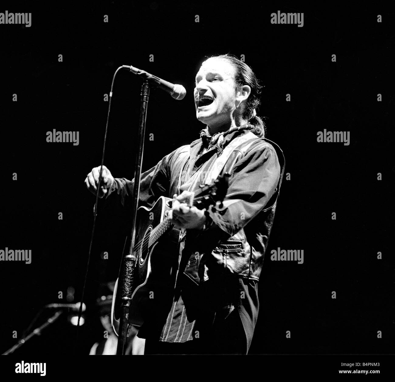 Rock group U2 in concert in USA May 1987 Bono singing and playing guitar Stock Photo