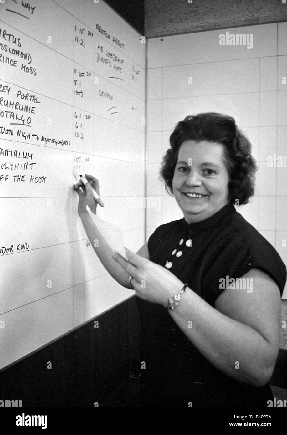Cashier Dorothy Penfold of a Ladies only betting shop in Worcester writing the odds on the board September 1968 Stock Photo
