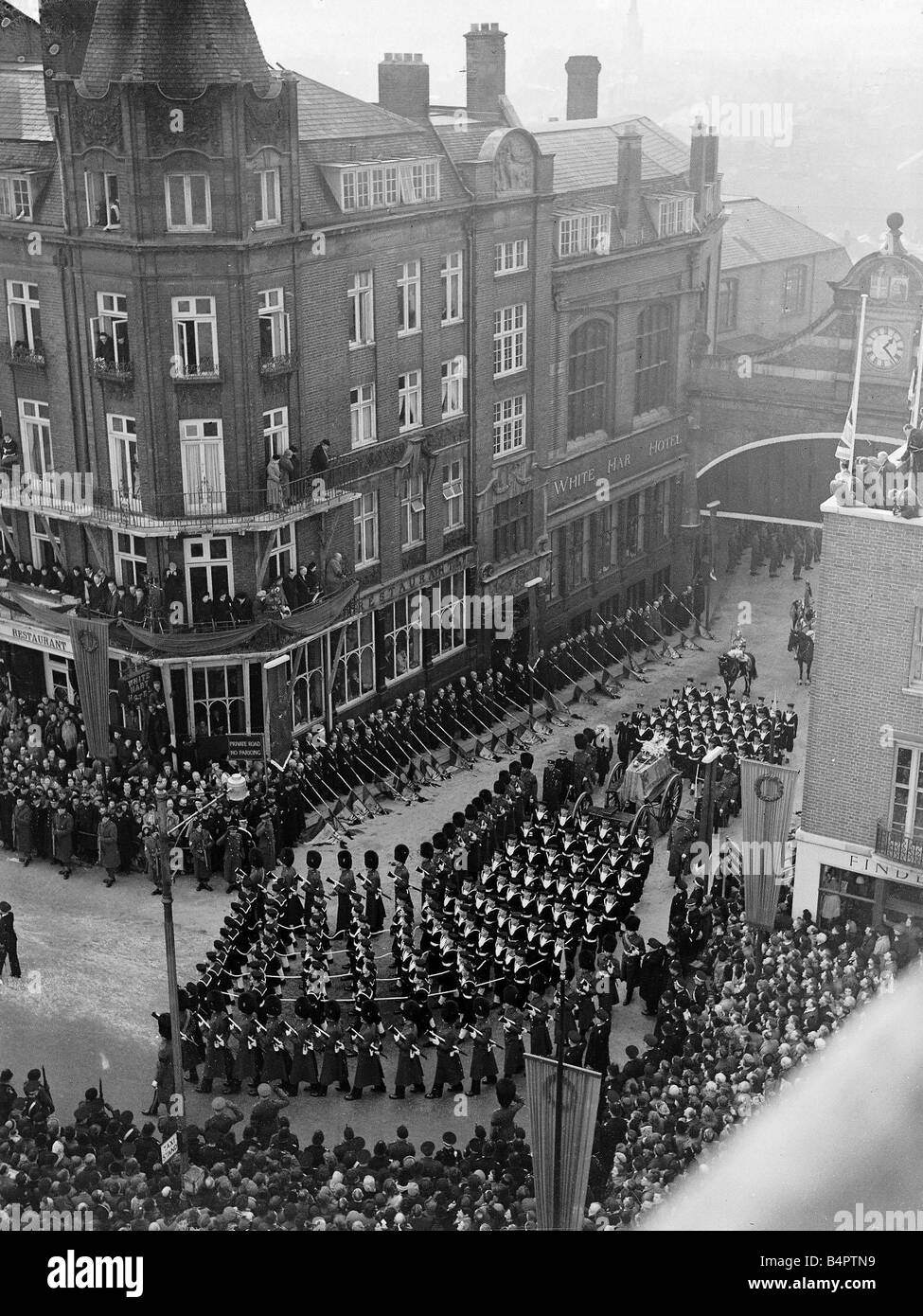 King George VI Death State Funeral The gun carriage with the coffin of King George is pulled through the streets of Windsor by sailors of the Royal Navy and flanked by soldiers of the Guards Stock Photo