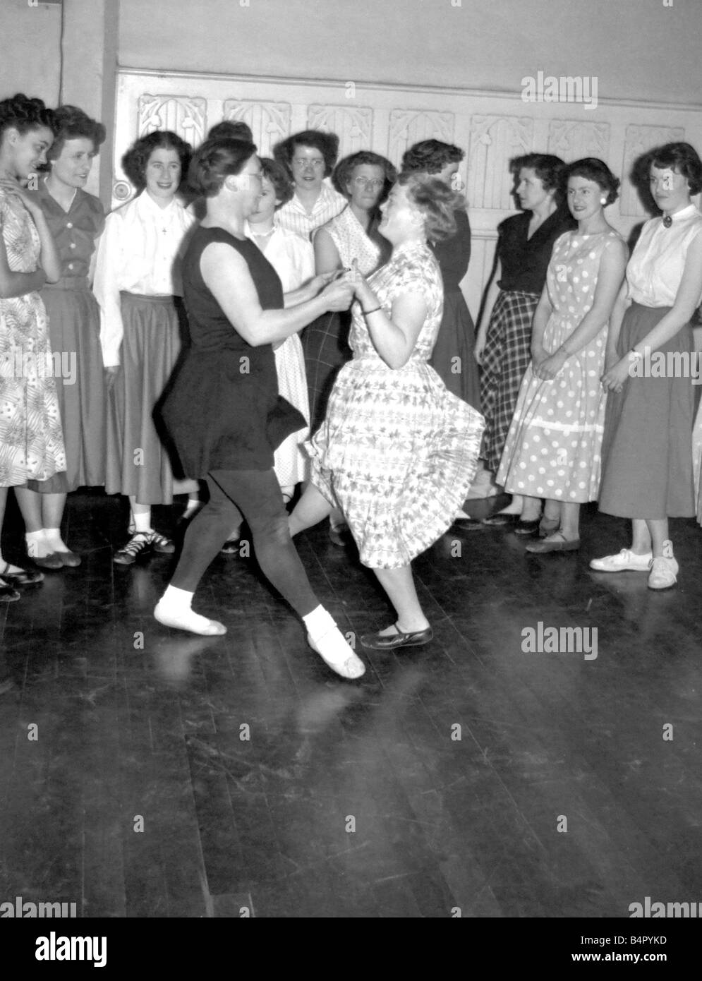 Mrs Sally Legg in black does a pas de basque and turn with a fellow member of her Scottish dancing class Miss Mary Wall a teache Stock Photo
