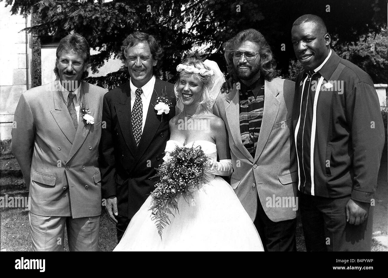 David English and his bride Robyn pose for the cameras with his best man Ian Botham Cricket and with Barry Gibb singer of the Bee Gees and with boxer Gary Mason dbase Stock Photo