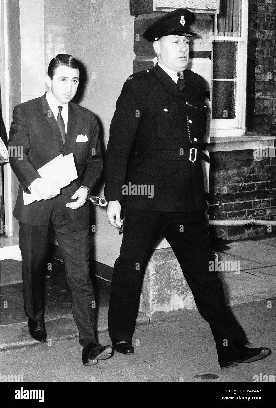 Roy James being escorted by a policeman January 20th 1964 The trial of ...