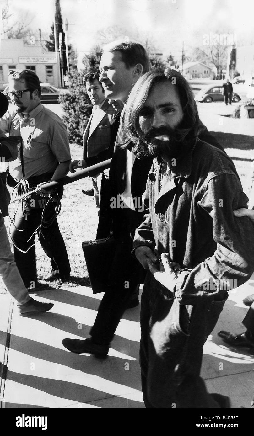 Charles Manson Hippie cult leader of Satan being lead away by police agents after being accused of six murders in which Sharon Tate is one of the victims Stock Photo