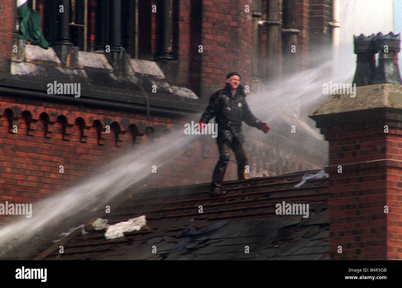 Strangeways Prison Riots 1990 prisoners on the roof demonstrating Rooftop protest by prisoners at Strangeways Prison 1990 in Machester The slates have been stripped from the roof and thrown to the ground below Stock Photo