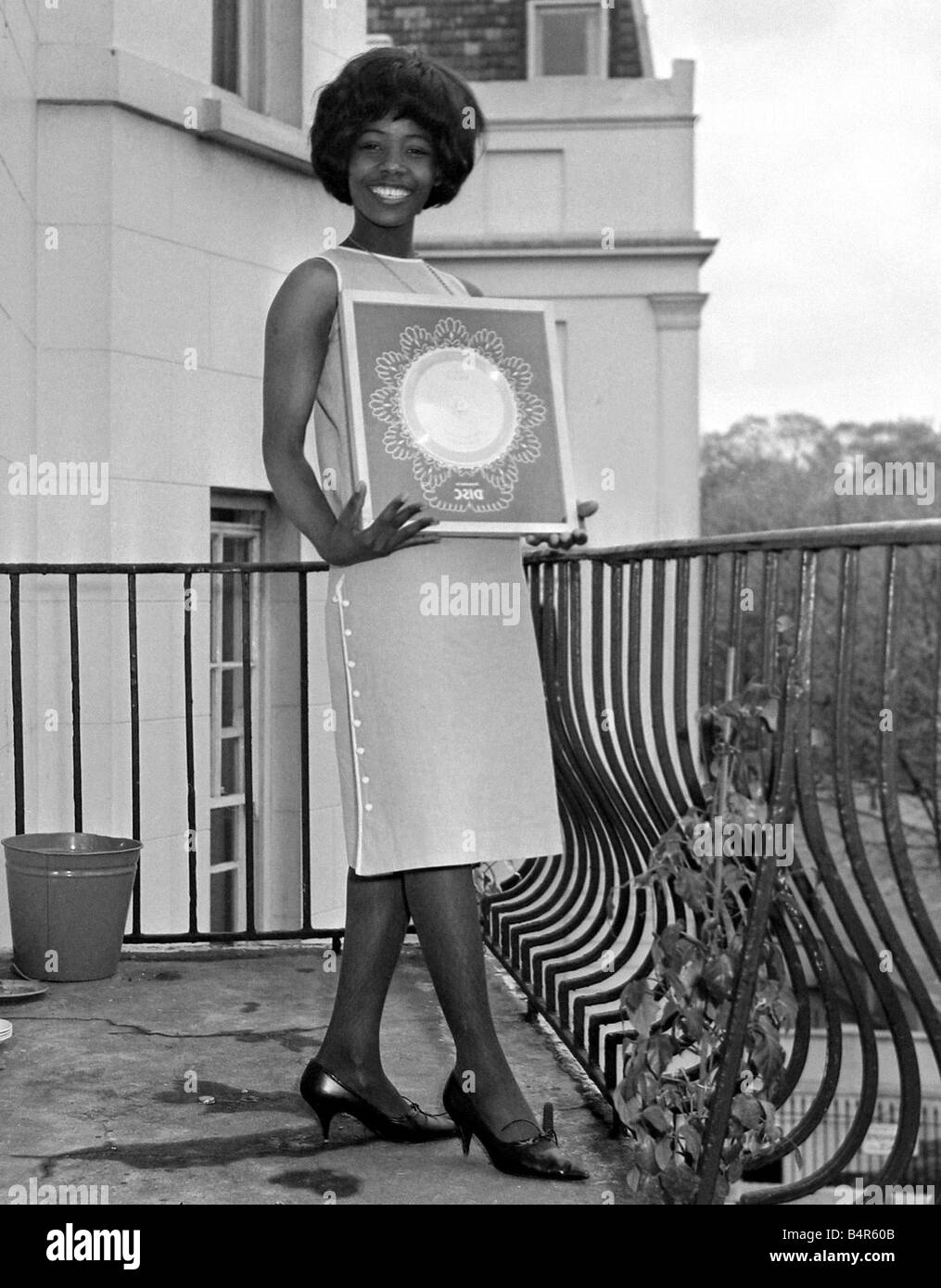 Millie Small Dynamic pop singer of My Boy Lollipop at a reception at Fontana Records where she received her silver disc for a quarter of a million sales from the former High Commissioner for Trinidad Sir Learie Constantine May 1964 1960s Stock Photo