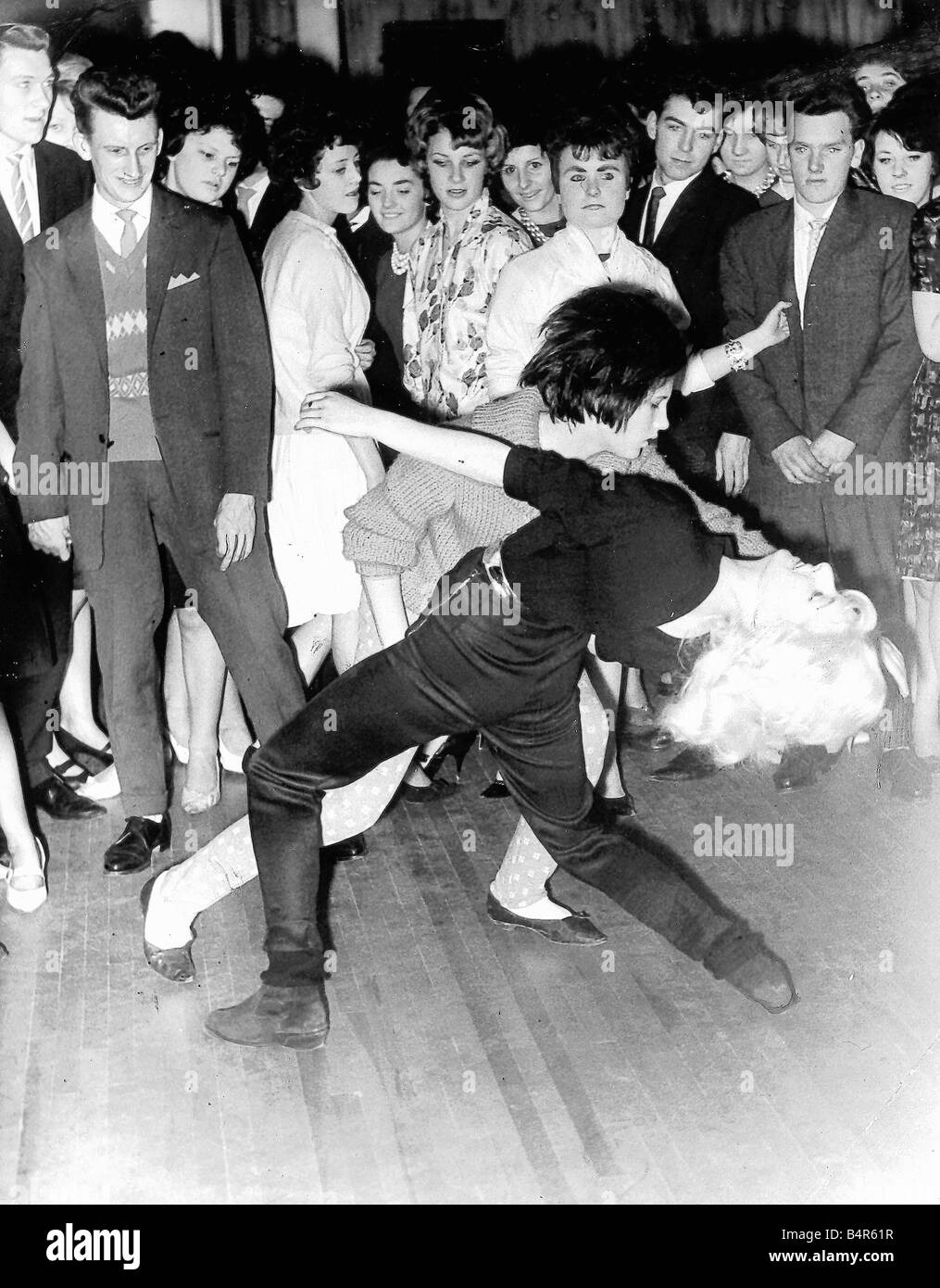 Young dancers crowd the floor for a twist dance Local Caption friendshipimages Stock Photo