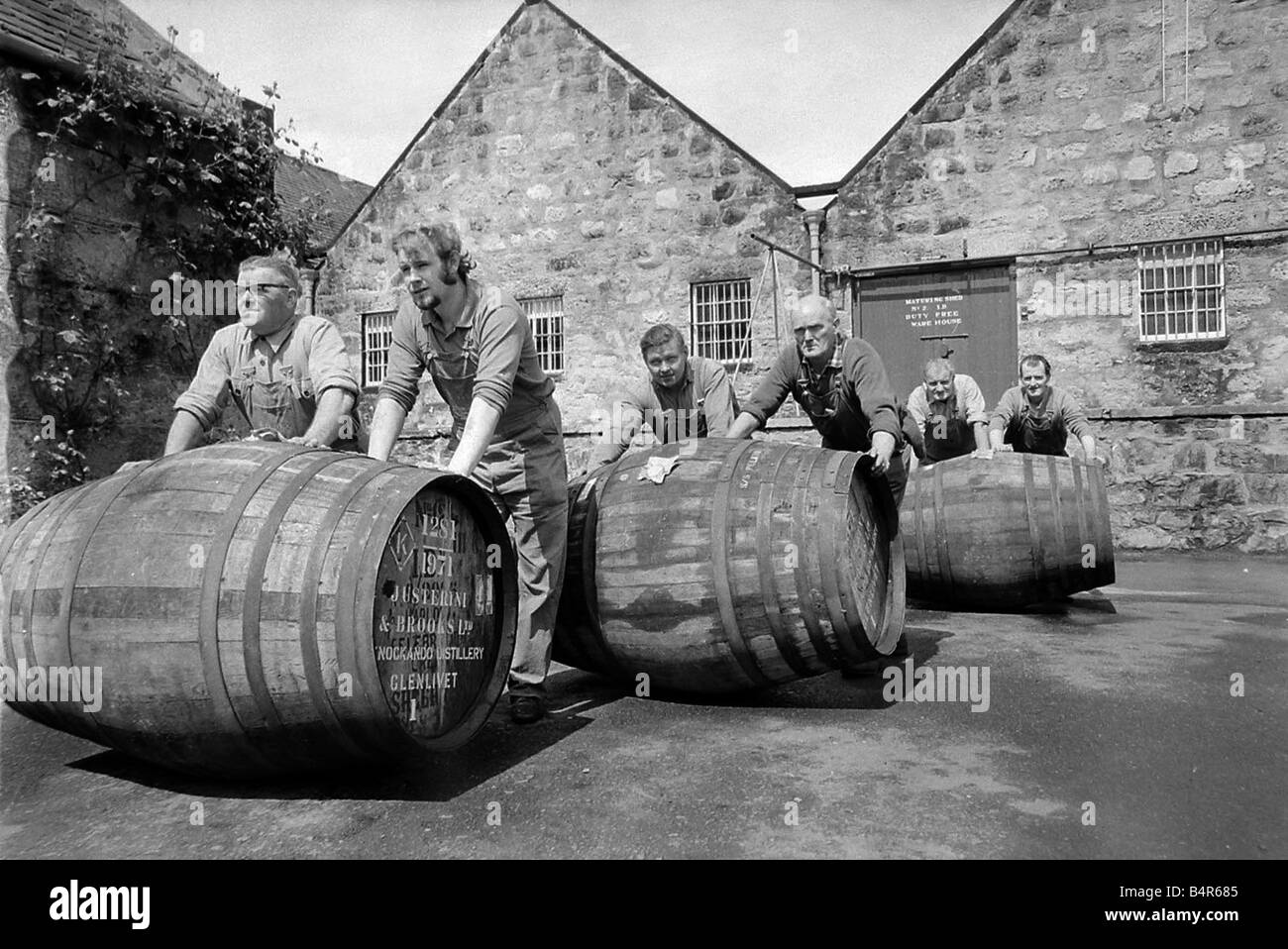 Workers Rolling Barrels Of Whisky To The Bonded Warehouse At The ...