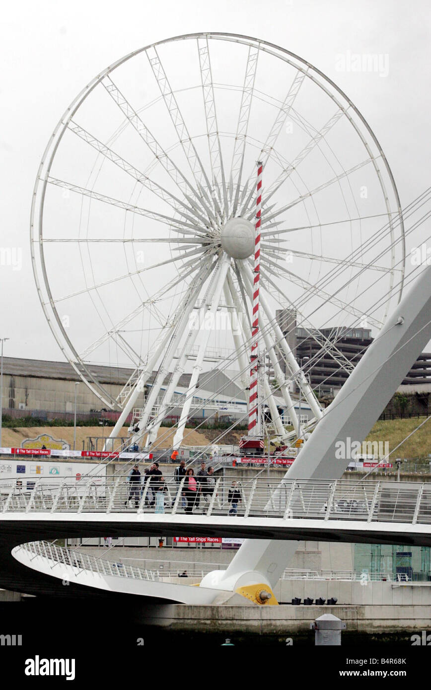 The Gateshead Eye Ferris wheel at Baltic Square seen through the Millennium Bridge 22 07 05