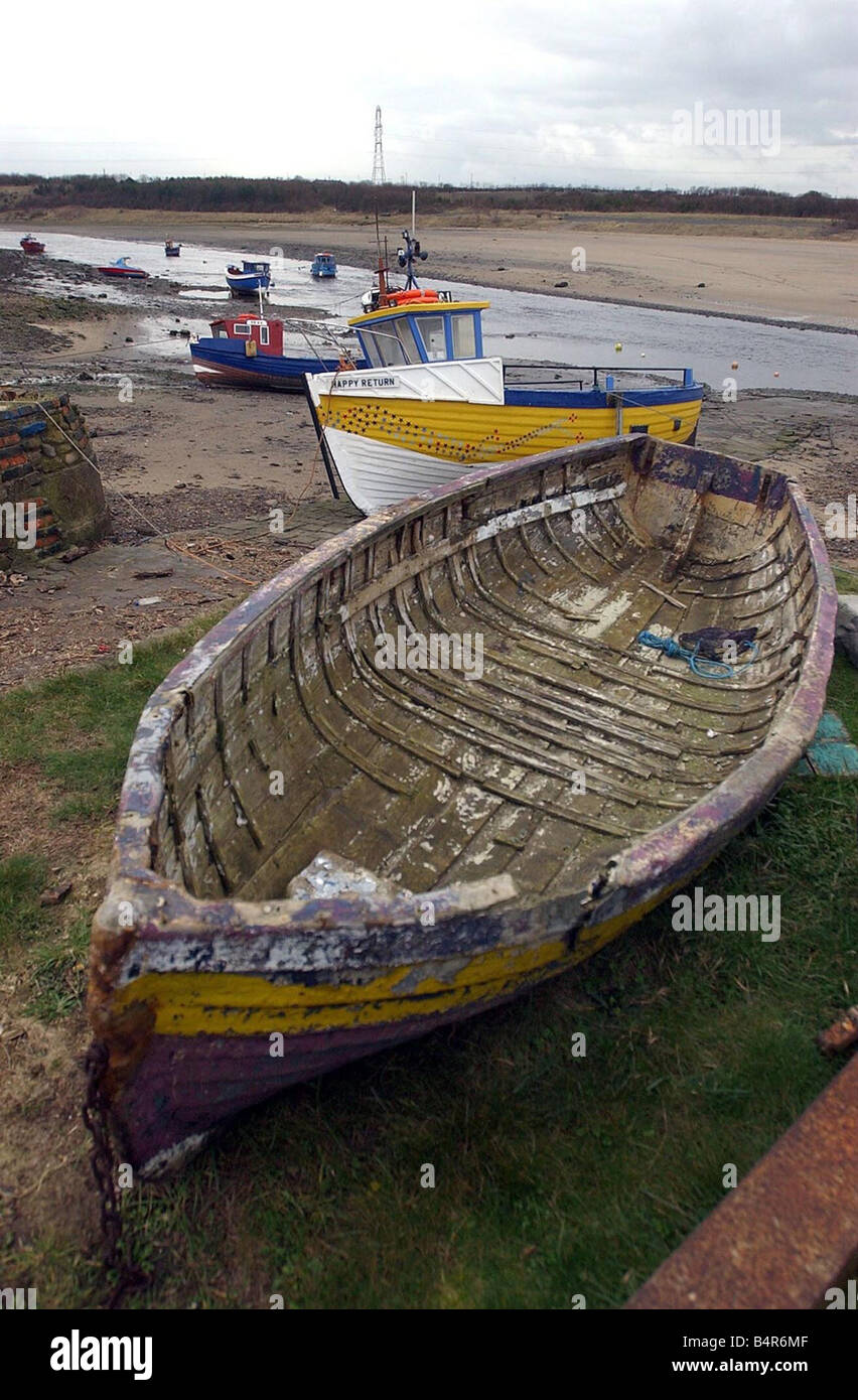 Low tide leaves boats stranded at Cambois at the mouth of the River Wansbeck in Northumberland Stock Photo