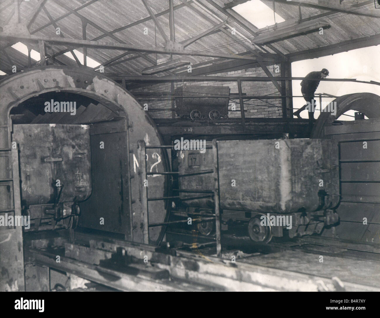 Shilbottle Colliery in March 1952 The new system of much larger mine cars is shown in operation whilst one of the old smaller tubs moves along the gantry in the background Stock Photo