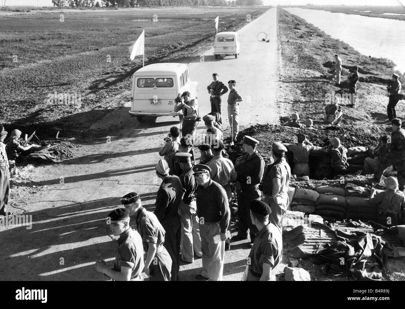 The Suez crisis part of the convoy of United Nations jeeps carrying white flags are here seen heading towards the egyptian lines which are situated besides the trees along the road 15 11 56 Stock Photo