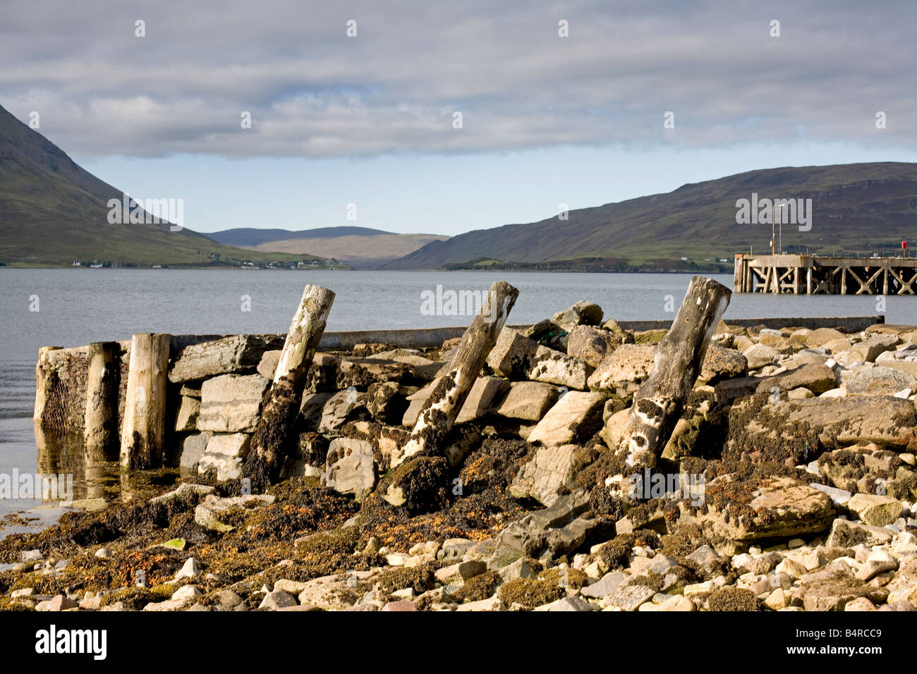 Old jetty and the ferry pier on the Isle of Raasay, view to the Cuillin moutains on the Isle of Skye, Scotland Stock Photo