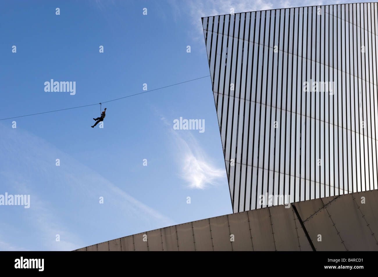 Ziplining from Imperial War Museum North at Salford Quays, Manchester, Great Britain Stock Photo