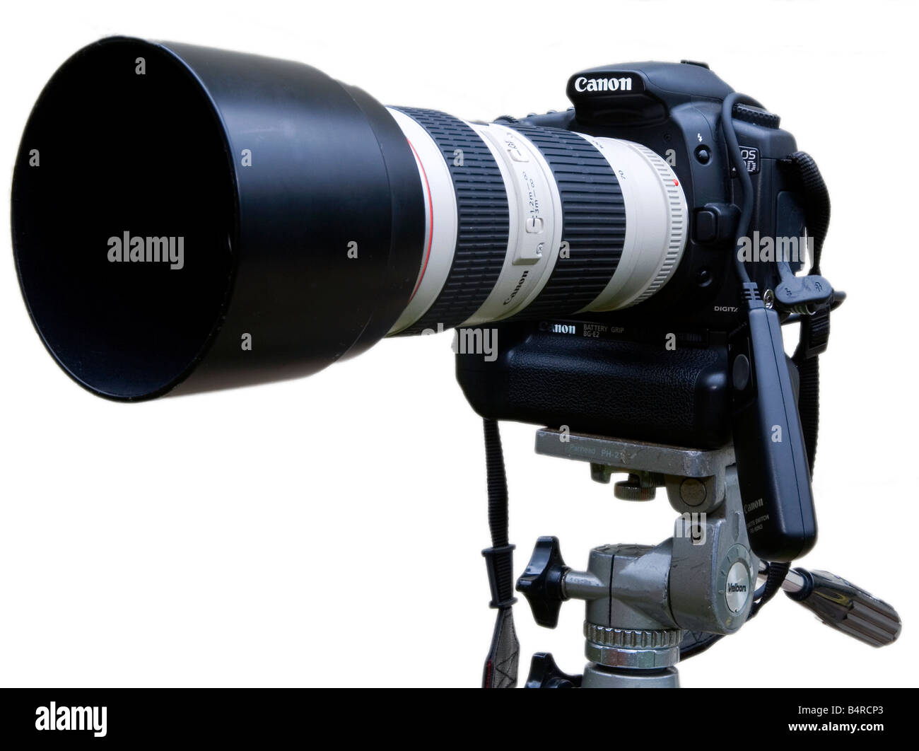 Canon digital SLR camera mounted on tripod with telephoto zoom lens and electronic cable release fitted Stock Photo