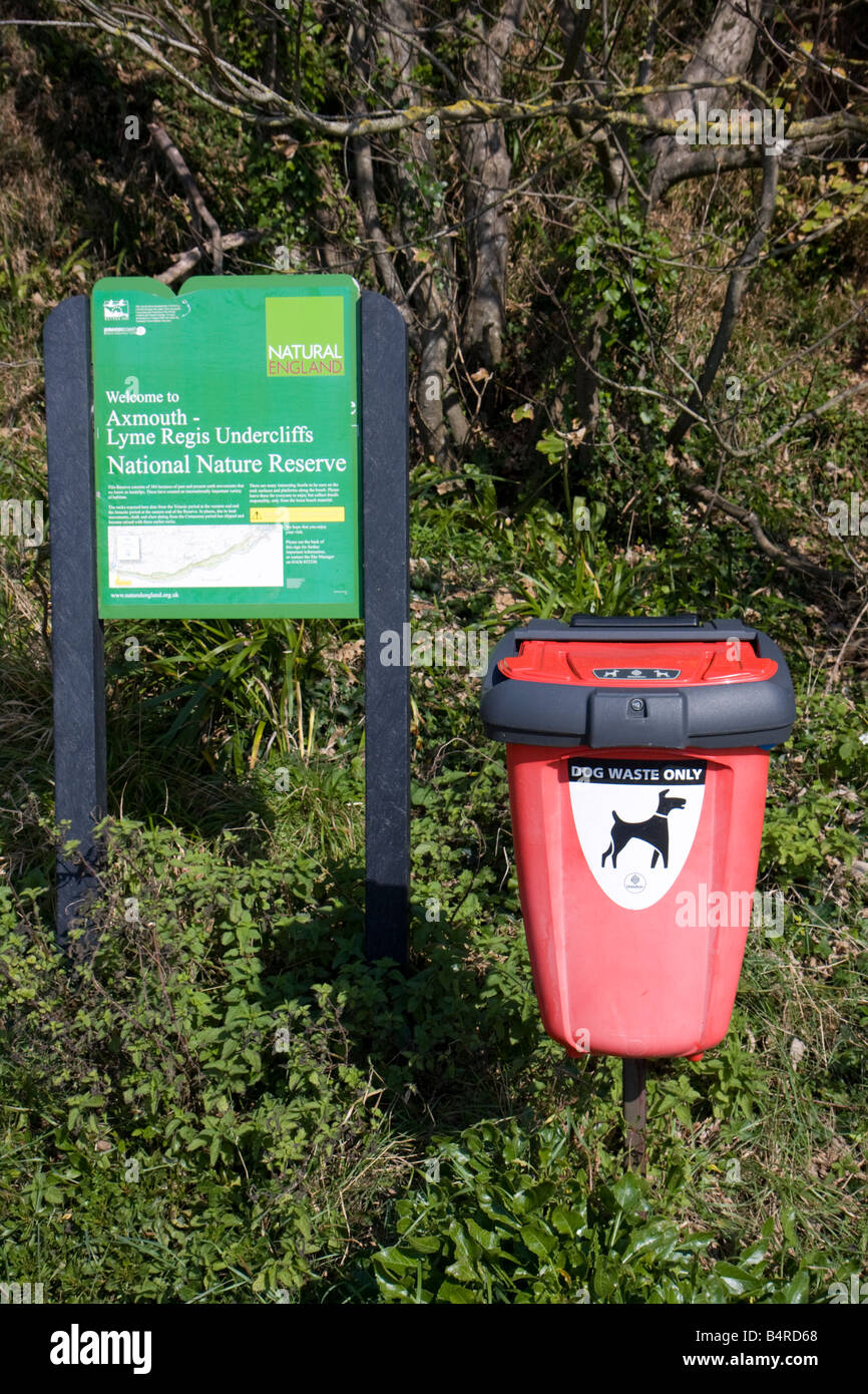 Dog waste bin and information sign in Axmouth - Lyme Regis Undercliffs National Nature Reserve at Axmouth, Devon Stock Photo