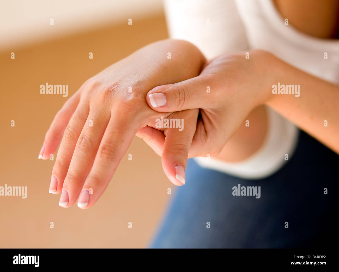 Woman massaging hands Stock Photo Alamy