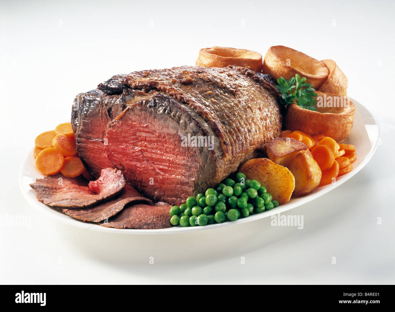 Roast beef joint vegetables editorial food Stock Photo Alamy
