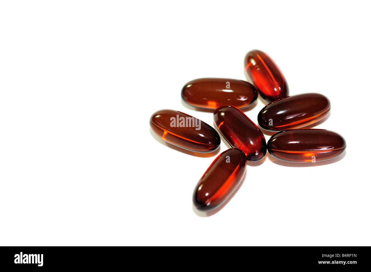 Six omega 3 and 6 flaxseed oil capsules on a white background. Silo, cutout. USA. Stock Photo