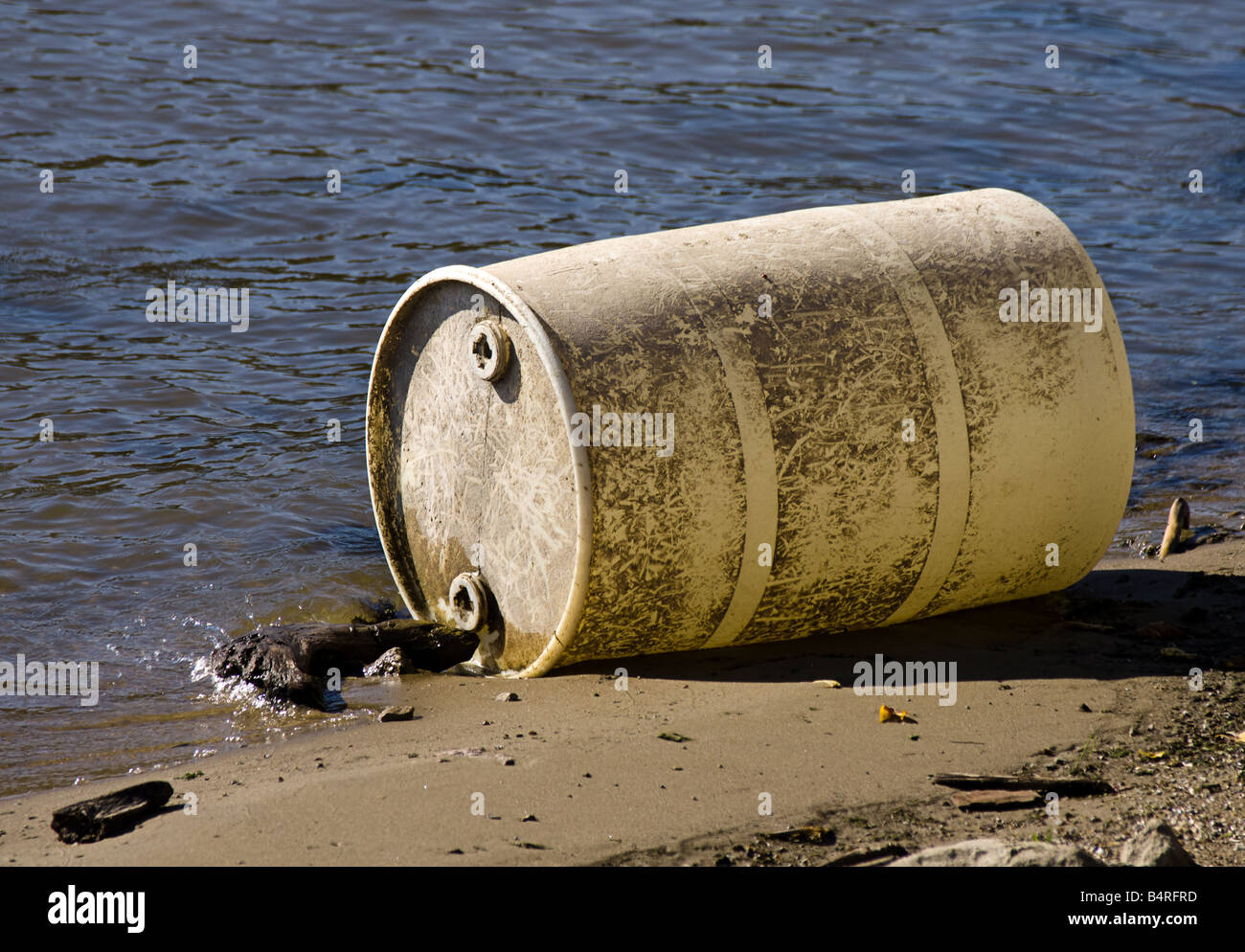 A plastic barrel that has washed up on the shores of the Mississippi river. Stock Photo