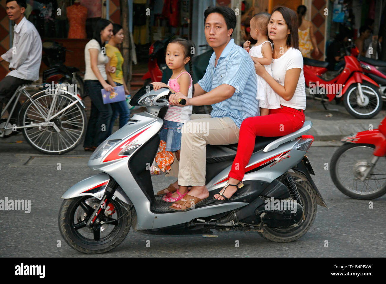 Family group on scooter, Hanoi North Vietnam Stock Photo