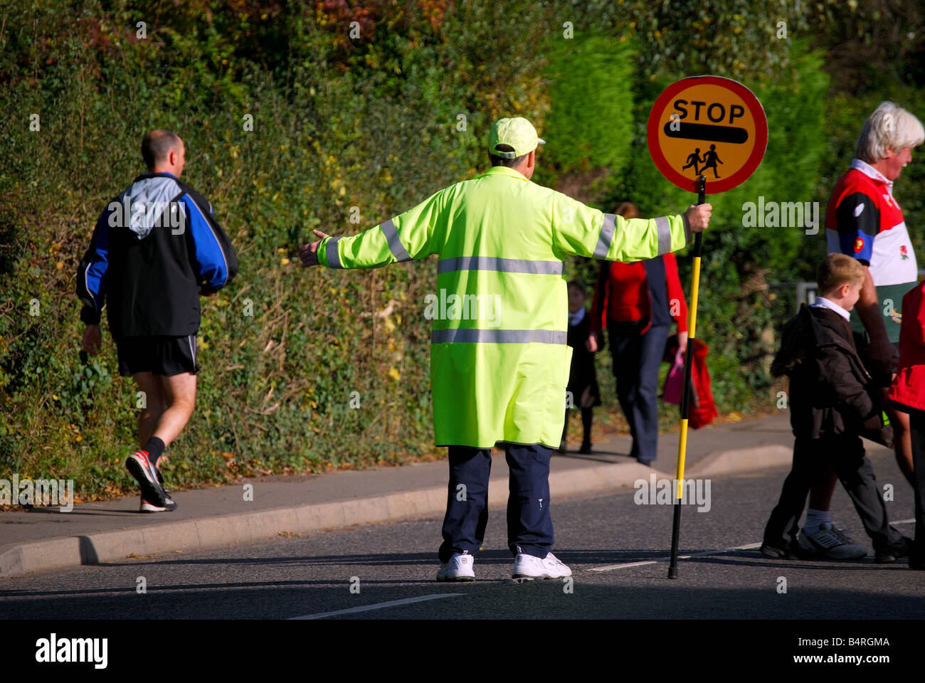 Lollipop man at pedestrian crossing, Sandhurst, Kent, United Kingdom Stock Photo