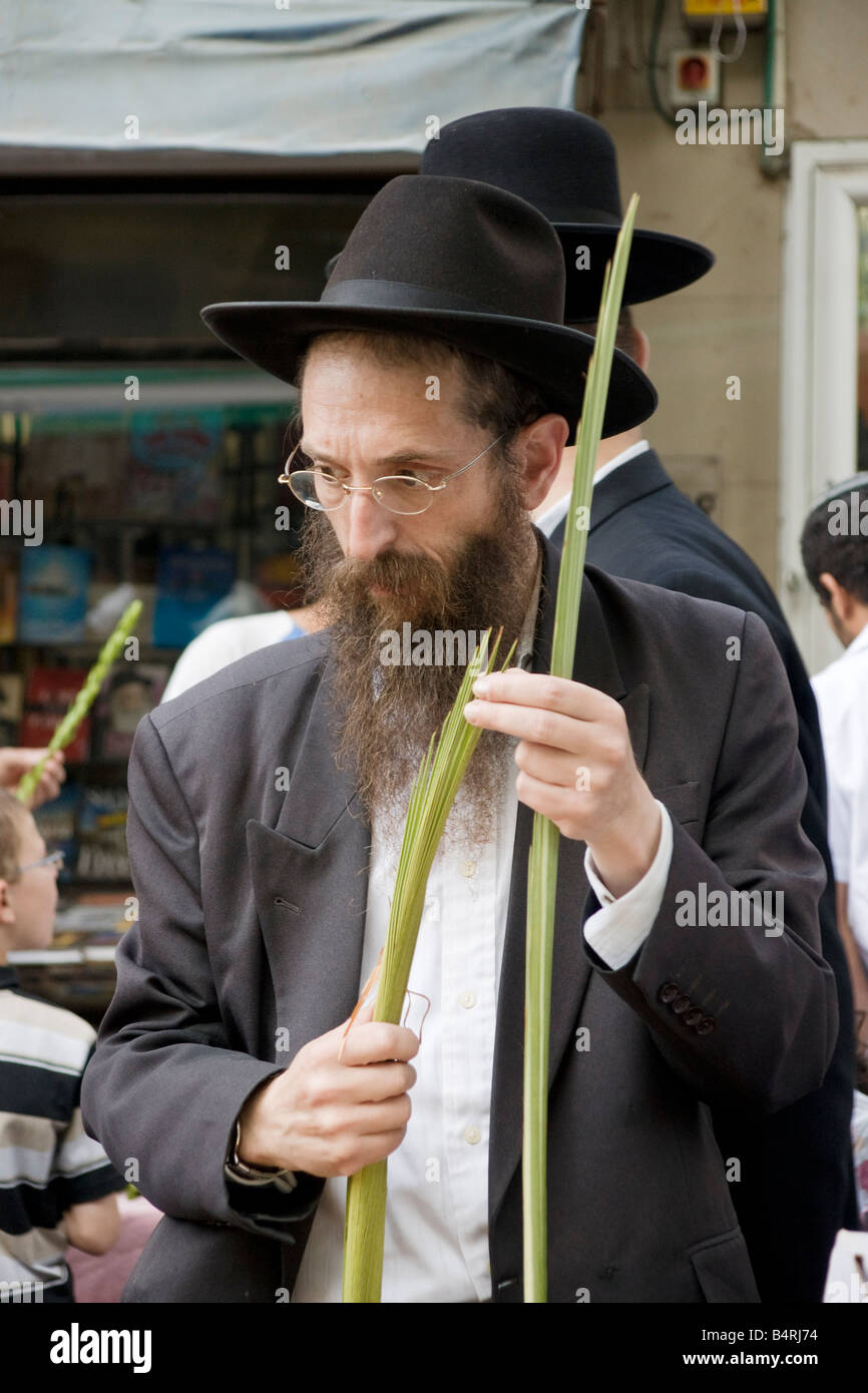 Jerusalem,Israel.An ultra-orthodox (Charedi) man checks a palm branch ('Lulav') for a Jewish ritual during the holiday of Sukot. Stock Photo