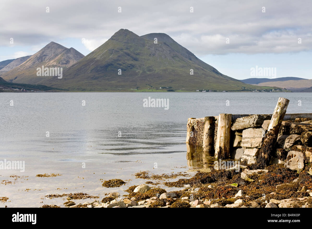 Old jetty and the ferry pier on the Isle of Raasay, view to the Cuillin moutains on the Isle of Skye, Scotland Stock Photo